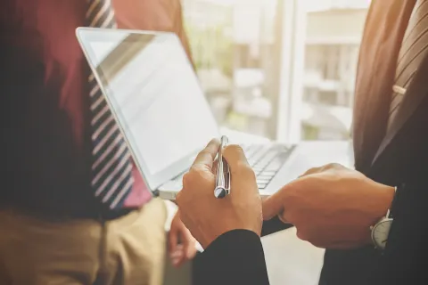 Woman manager putting her ideas and writing business plan at workplace, making notes in documents on the table in office